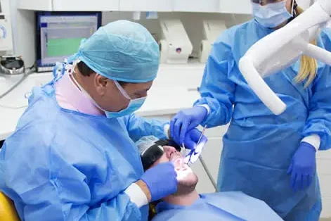 specialist dentist providing dental treatment at Queen’s Gate Dental Practice in South Kensington, London, UK