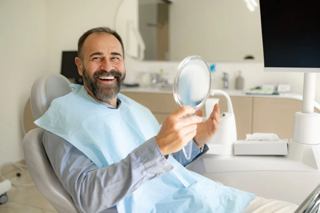 man smiling after teeth whitening treatment