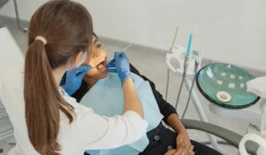 Dental hygienist performing hygiene treatment on a female patient